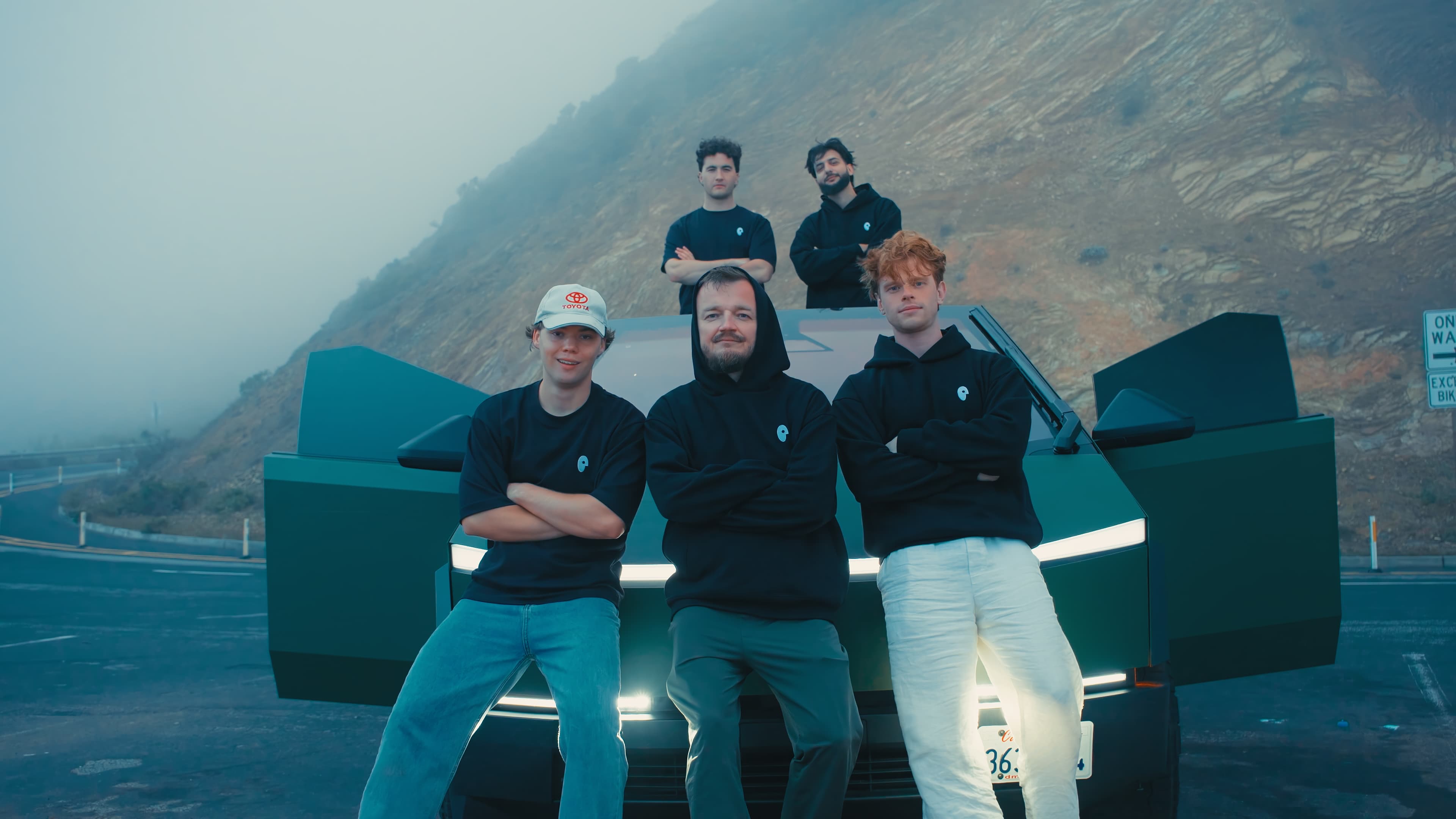 Five members of the Boski team in front of a car with its doors open.