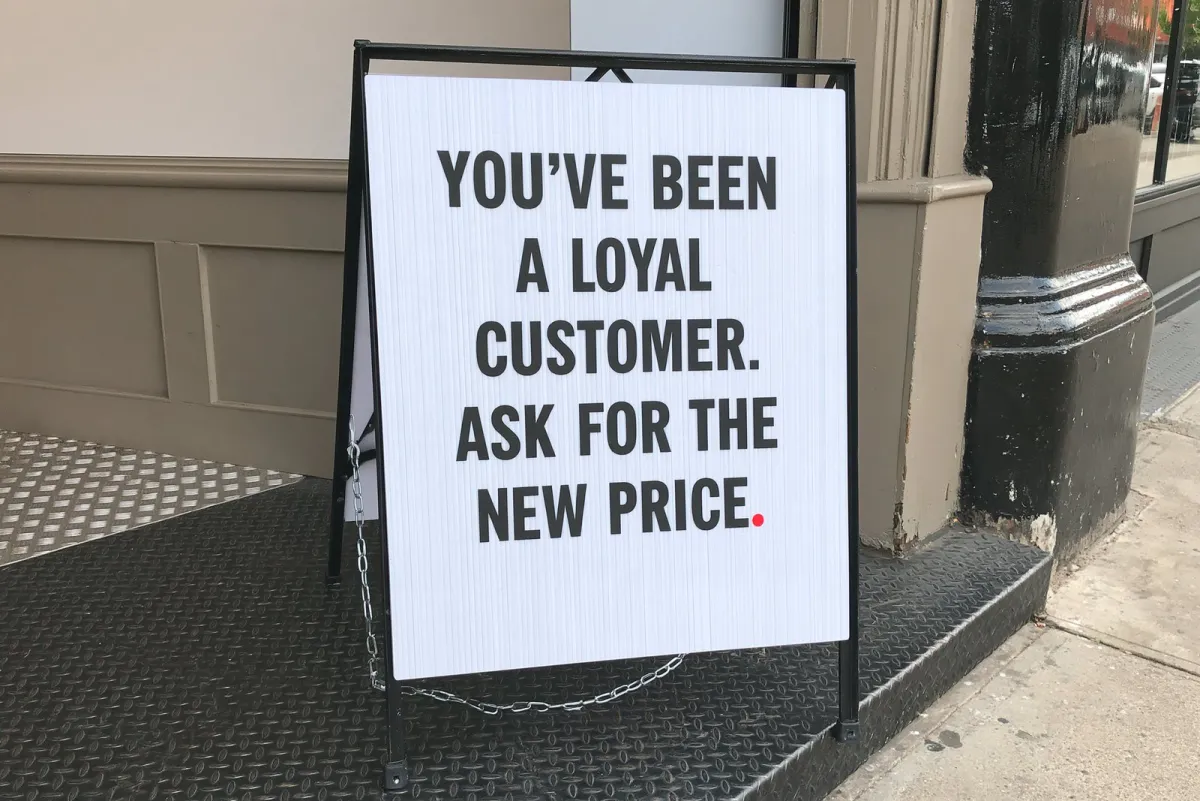 Sidewalk letterboard: "You've been a loyal customer. Ask for the new price."