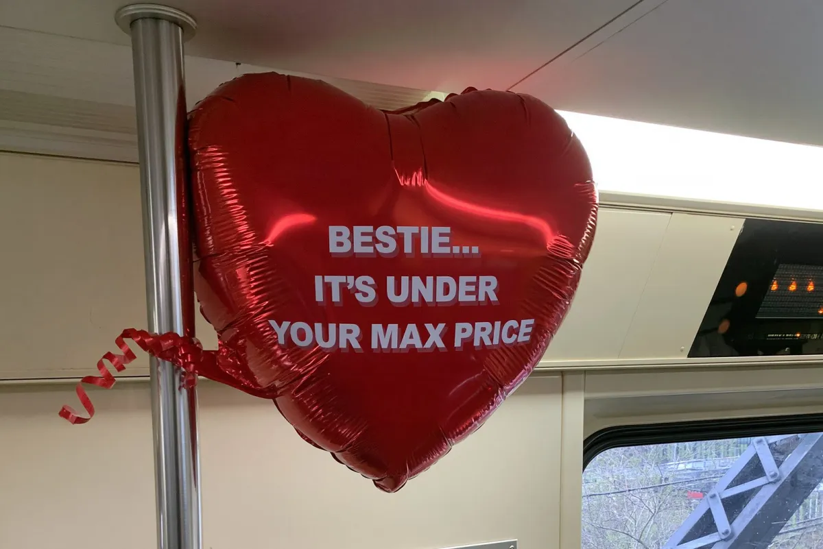 Heart balloon on a train: "Bestie... it's under your max price"